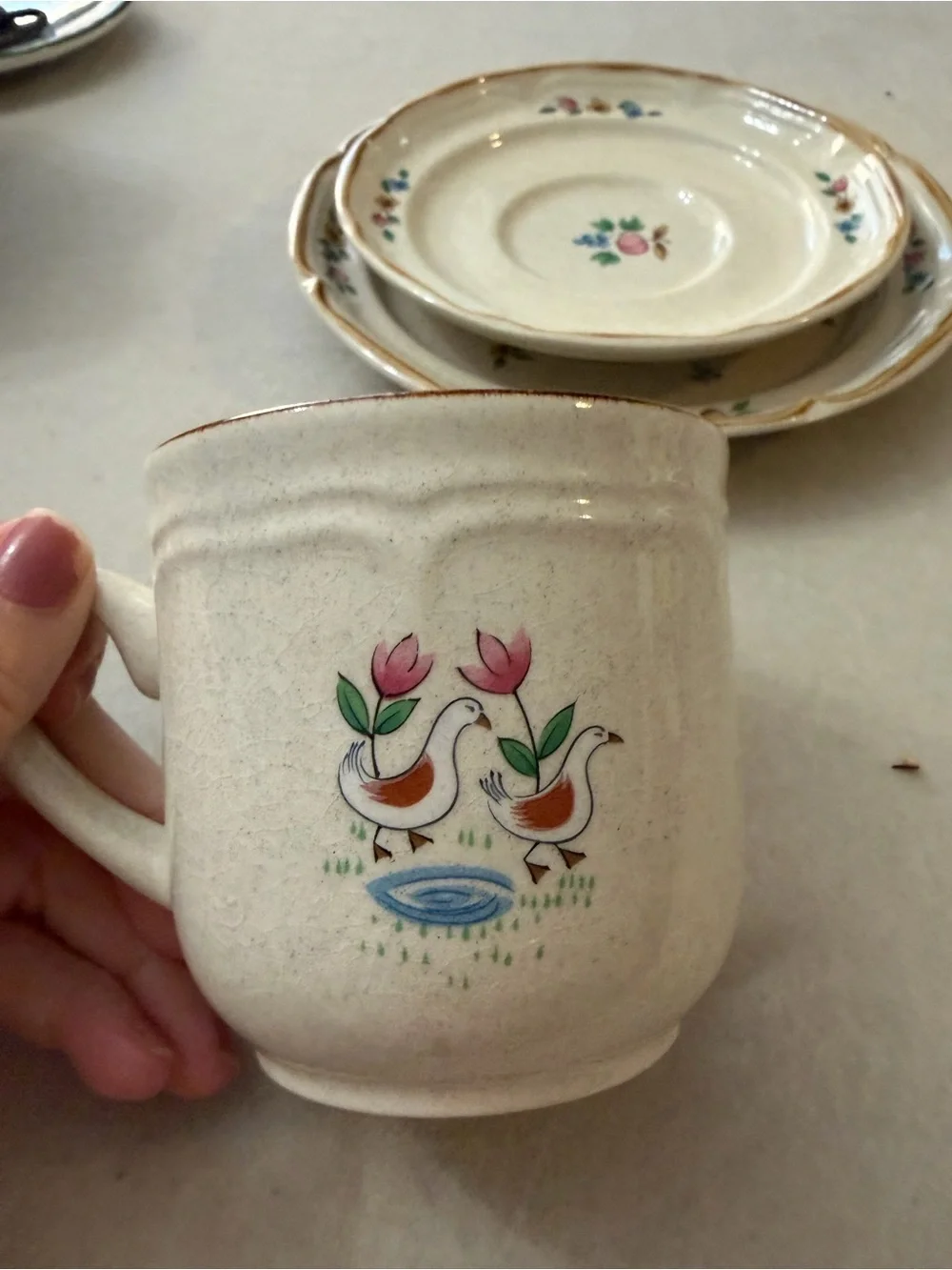 International Cream Ceramic Cup and Saucer Set with Hand-Painted Village Design